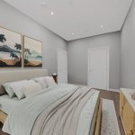 Modern bedroom with artwork and neutral decor.