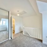 Bright loft room with mirrored wardrobe and en-suite bathroom.