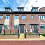 Modern redbrick townhouses with blue sky background