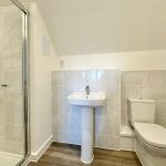 Modern bathroom with shower, sink, and toilet