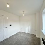 Empty room with modern grey carpet and large window.