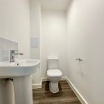 Modern bathroom with toilet and sink.
