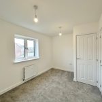 Empty room with carpet and large window.
