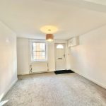 Empty room with window and front door