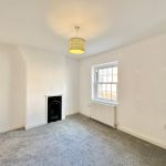 Empty room with fireplace and window