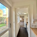 Bright hallway with garden view through window.