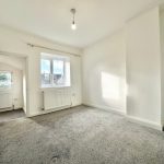 Bright empty room with carpet and large window.
