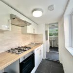 Modern kitchen with wooden countertops and appliances.