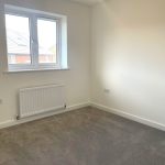 Empty room with carpet and window.