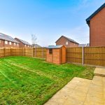 Fenced garden with shed and lawn