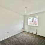Unfurnished bedroom with window and carpeted floor