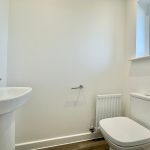 Modern bathroom with toilet and sink.