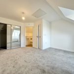 Spacious bedroom with en-suite and mirrored wardrobe.