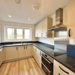 Modern kitchen with sleek cabinets and appliances.