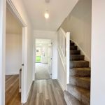 Modern hallway with staircase and wooden floor
