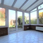 Sunlit conservatory with garden view.