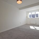 Bright empty room with carpet and window