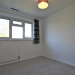 Empty room with window and radiator.