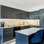 Modern kitchen interior with grey cabinets and island