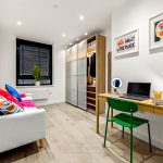 Modern room with sofa and desk setup.