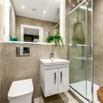 Modern bathroom with shower, sink, and toilet.