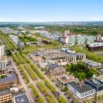 Aerial view of modern cityscape and greenery.