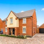 Modern red-brick house with driveway and garage