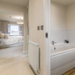Modern bathroom and bedroom in a bright home