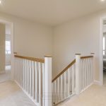 Modern hallway and staircase with bedroom views.