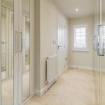 Modern hallway with mirrored wardrobes and radiator
