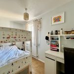 Child's bedroom with bunk bed and study desk.