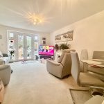 Modern living room with guitar and TV.
