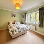 Cosy bedroom with bed and window view.