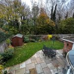 Back garden with shed, patio, and trees.