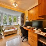 Cosy home office with large window and desk.
