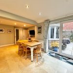 Bright dining room with patio access and garden view.