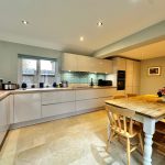 Modern kitchen with wooden dining table.