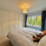 Cosy bedroom with wardrobe and window view