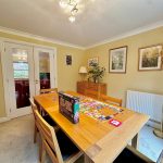Cosy dining room with puzzle on wooden table.
