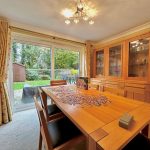 Bright dining room with jigsaw puzzle on table.