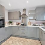 Modern grey kitchen with appliances and worktop.