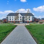Modern housing estate with green spaces and pathways.