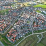 Aerial view of suburban housing estate and fields.