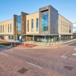 Modern health centre exterior with glass facade.