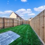 Garden with wooden fence and lawn