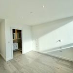 Empty bright room with wooden floor and window