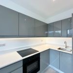Modern kitchen with grey cabinets and white countertops