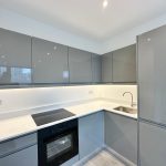Modern grey kitchen with induction hob and sink.