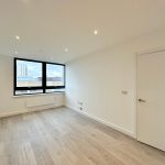 Spacious modern room with large window view.