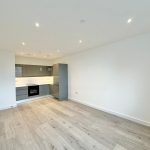 Modern kitchen with wooden flooring and grey cabinets
